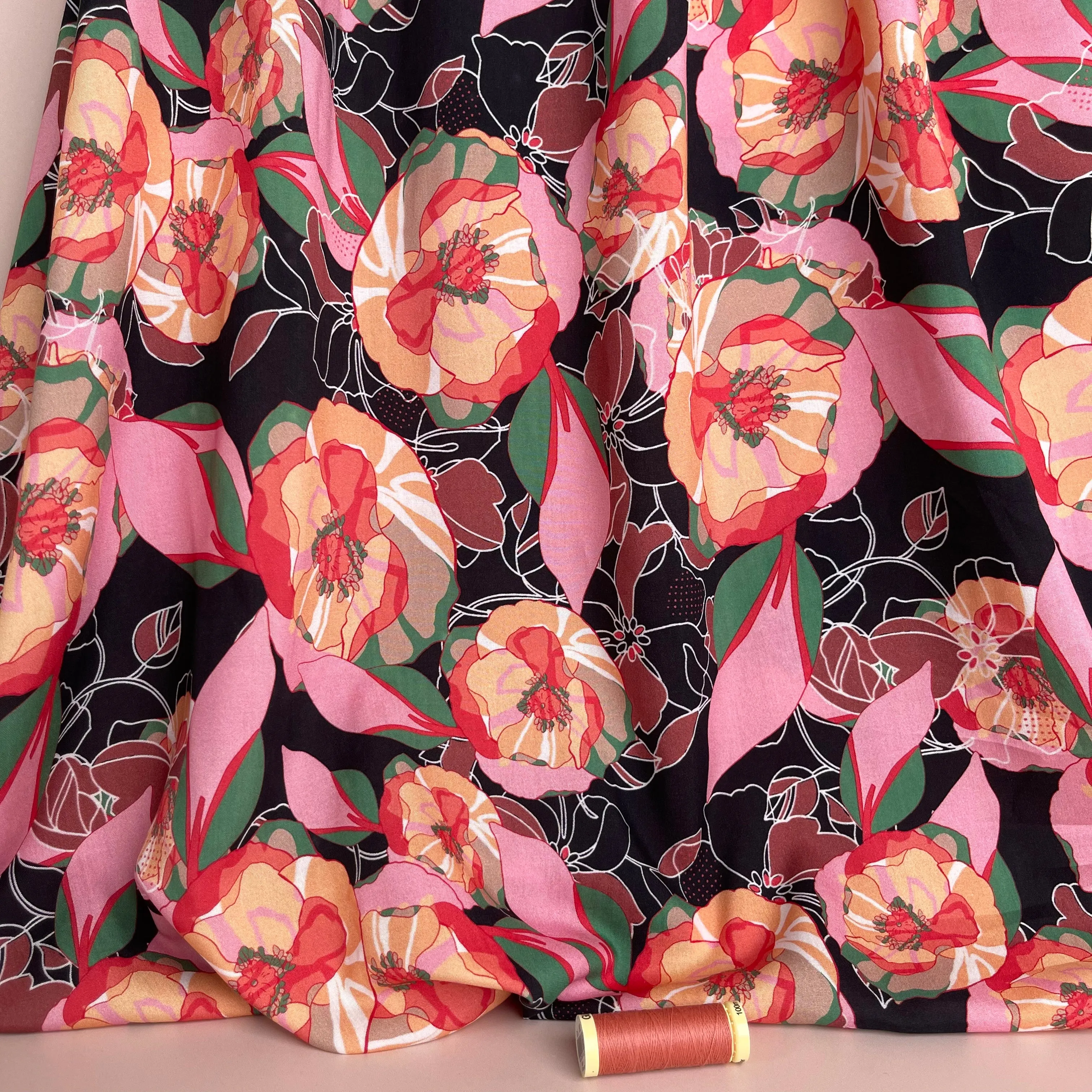 Vibrant Flowers on Black Viscose Fabric