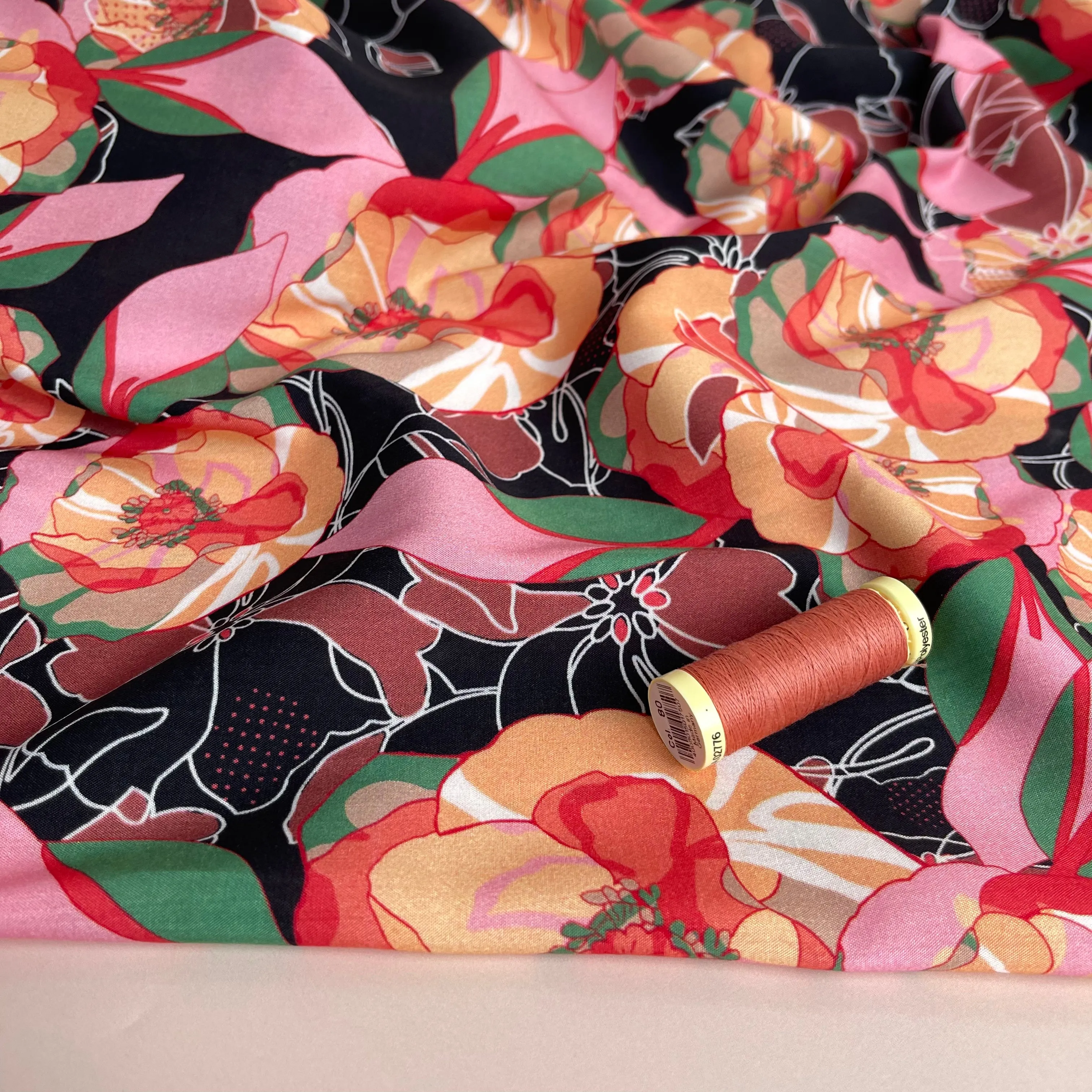 Vibrant Flowers on Black Viscose Fabric