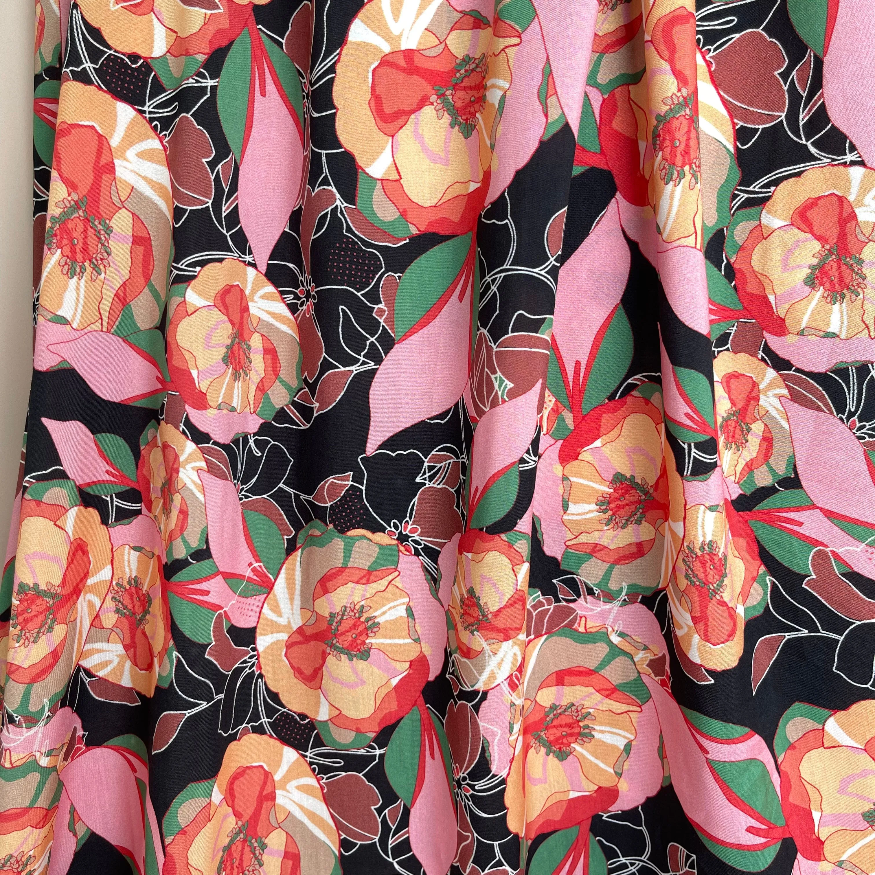 Vibrant Flowers on Black Viscose Fabric