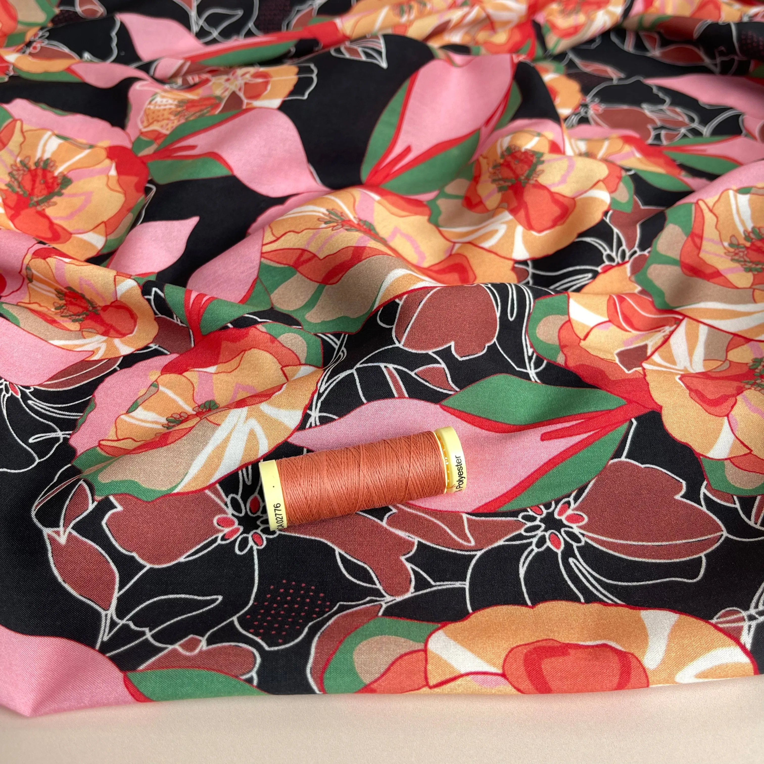 Vibrant Flowers on Black Viscose Fabric