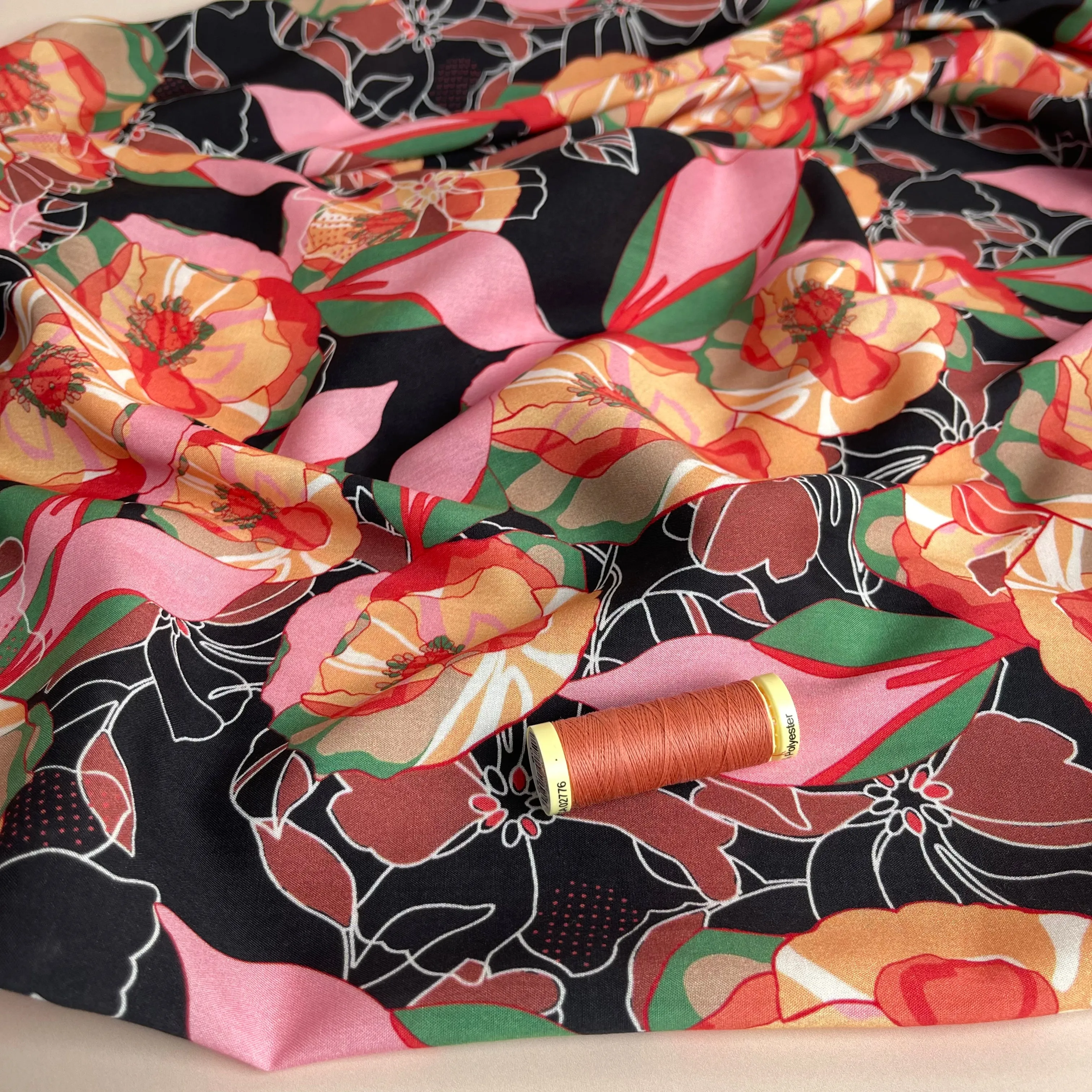 Vibrant Flowers on Black Viscose Fabric