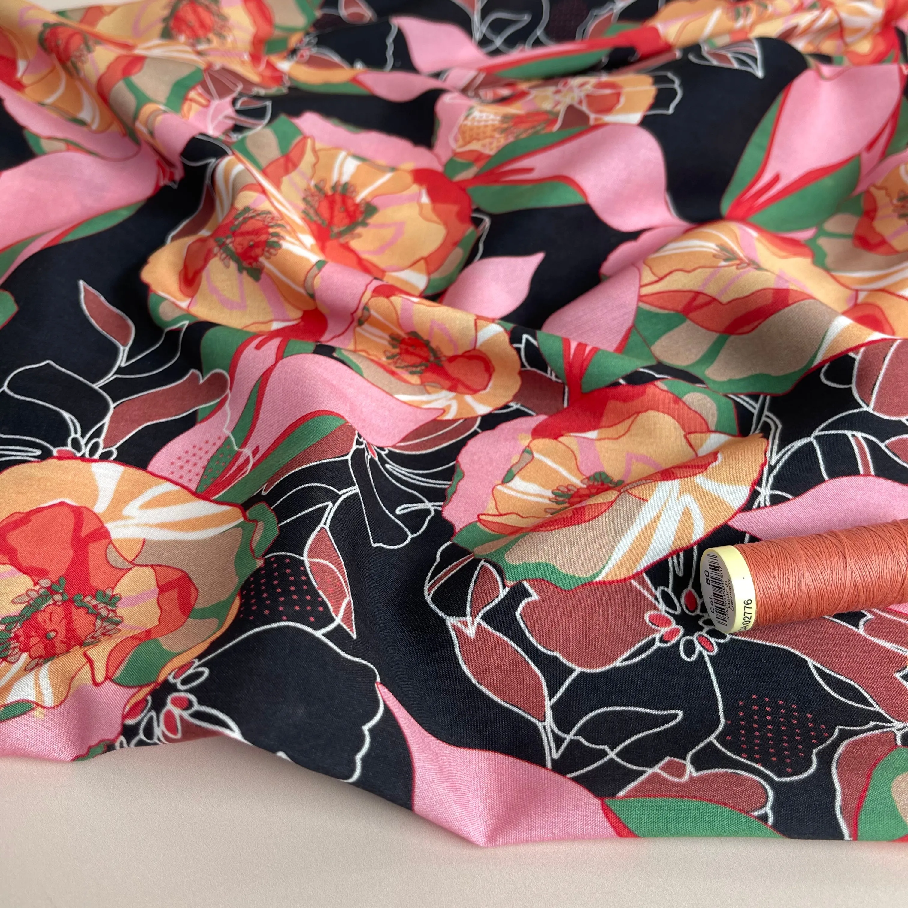 Vibrant Flowers on Black Viscose Fabric